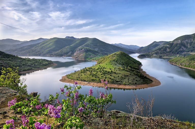 Beautiful view of the Arda River curving through lush green hills on a clear day.