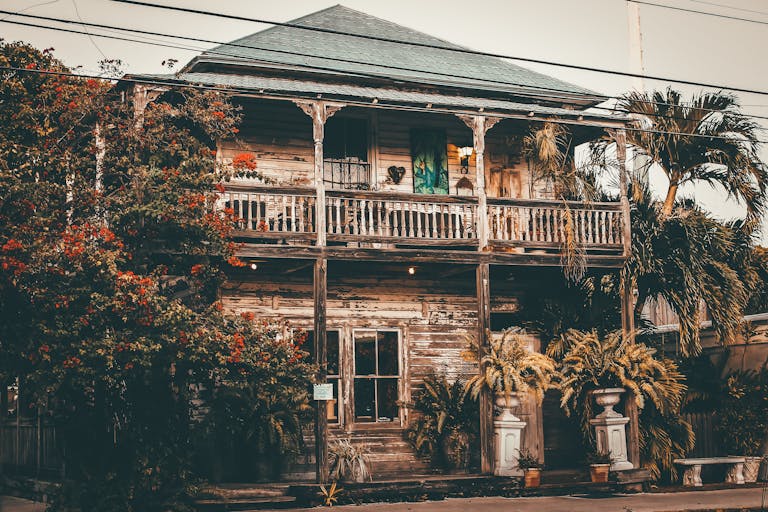 Explore a rustic vintage wooden house surrounded by tropical foliage in Key West, FL.