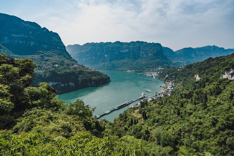 Experience the breathtaking scenery of the Yangtze River gorge with lush greenery and majestic mountains.